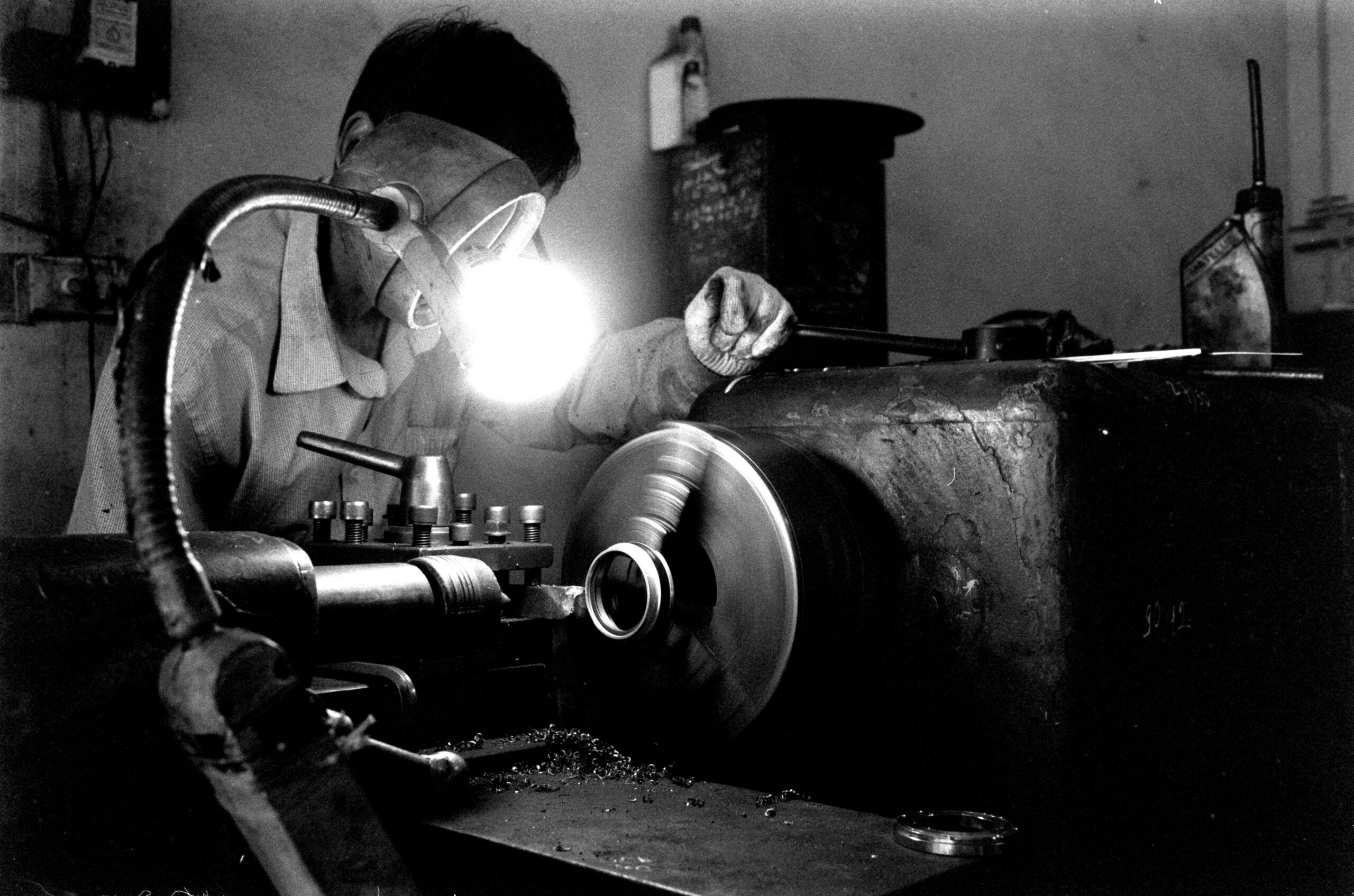 Portrait of a machinist focused on metalwork in a factory.