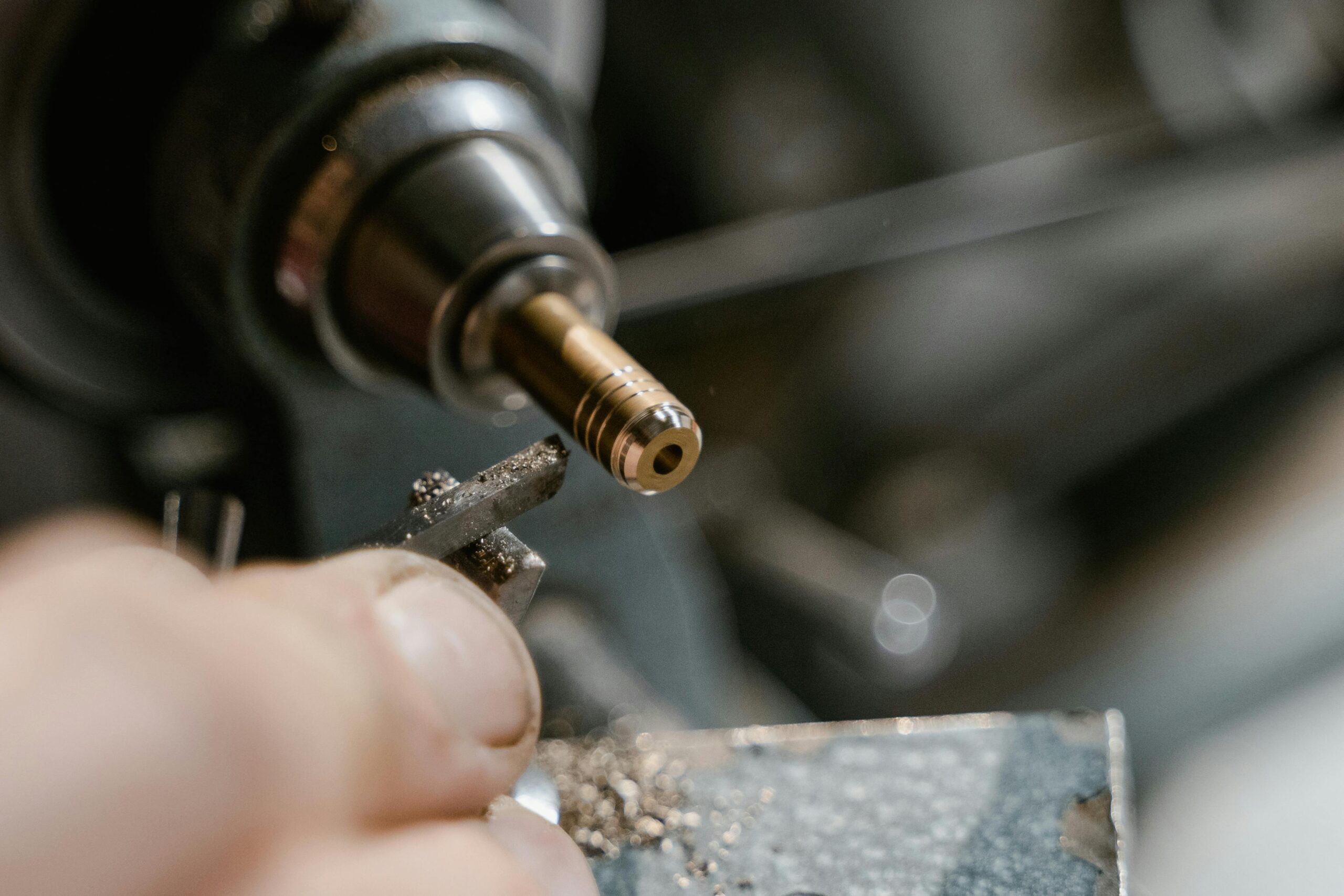 Detailed view of metalworking with a lathe in a workshop setting.